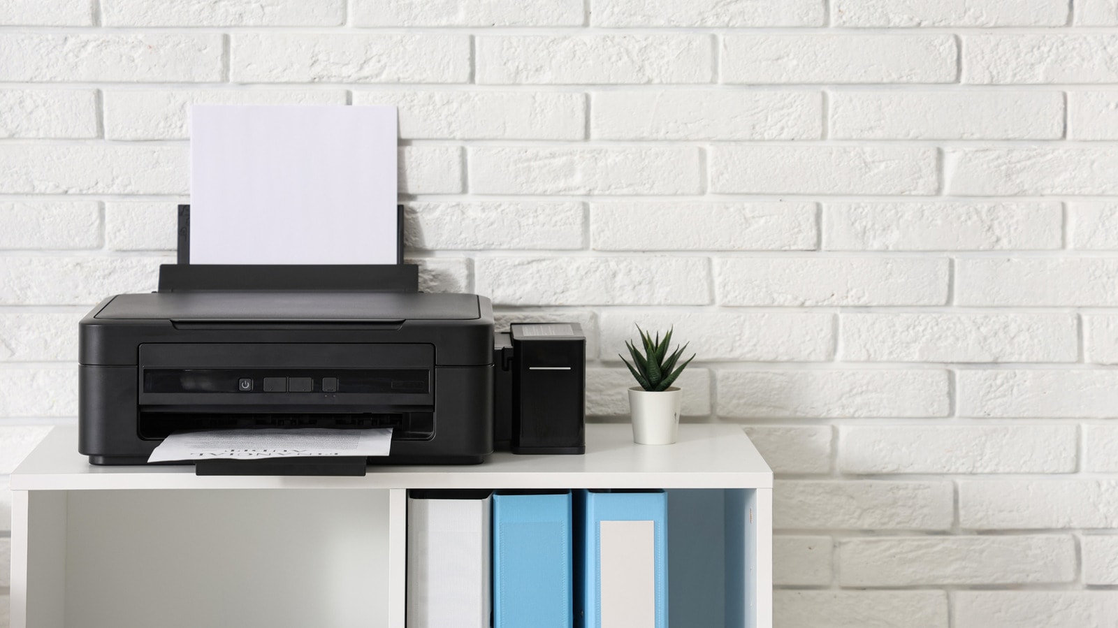 An iPhone displayed next to a modern printer