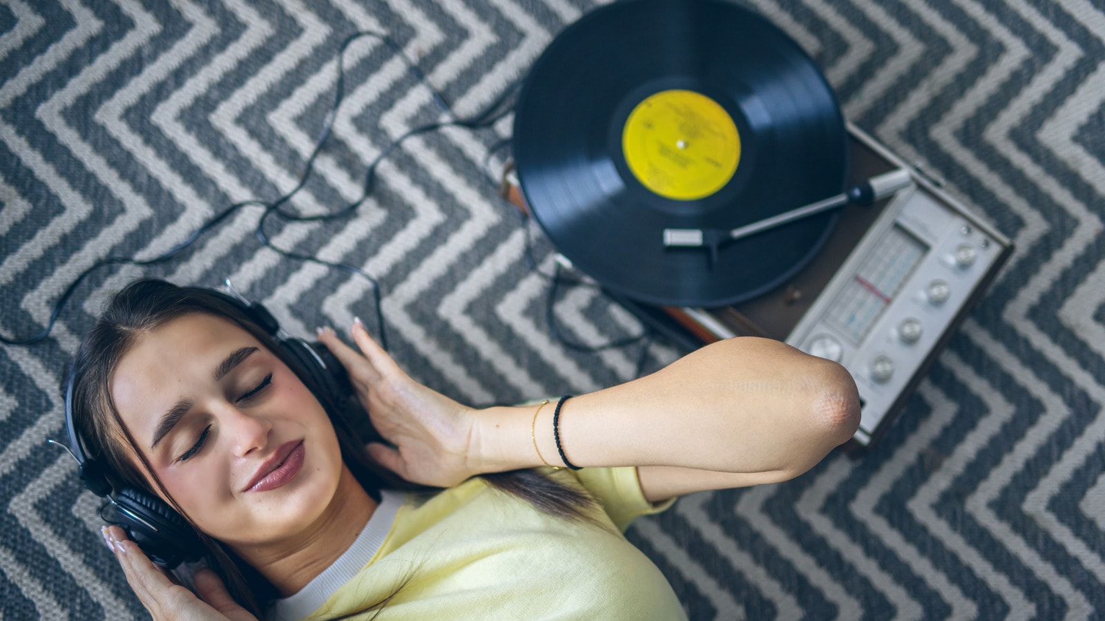 A close-up of a vinyl record stylus playing a record.