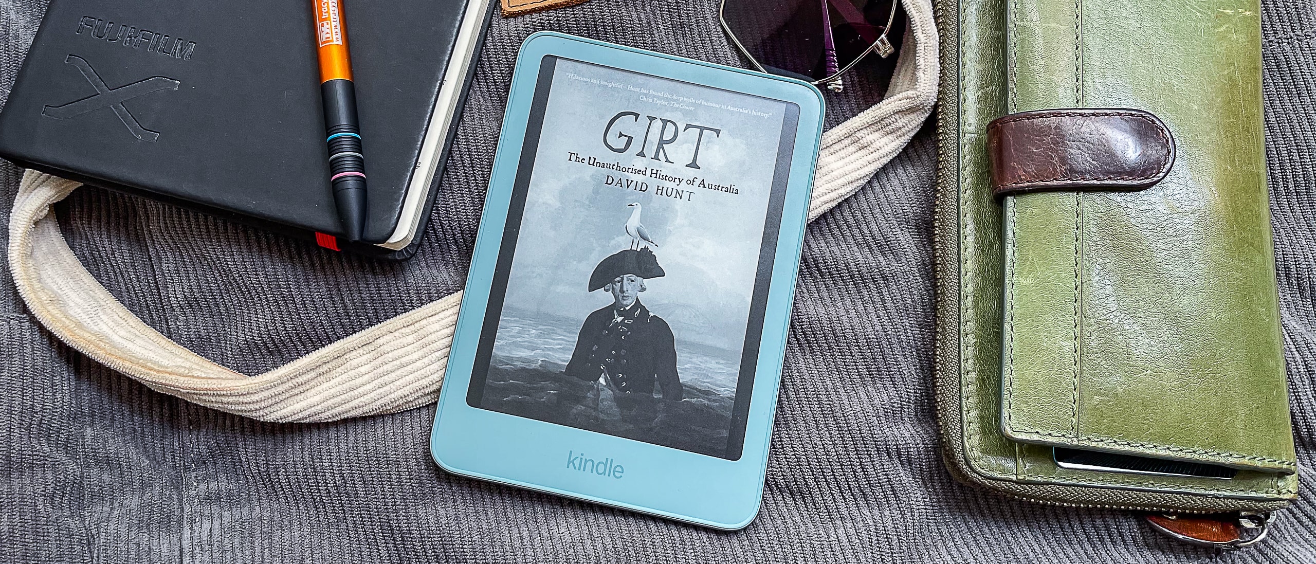 The new 2026 Amazon Kindle model held in a hand showing its slim design.