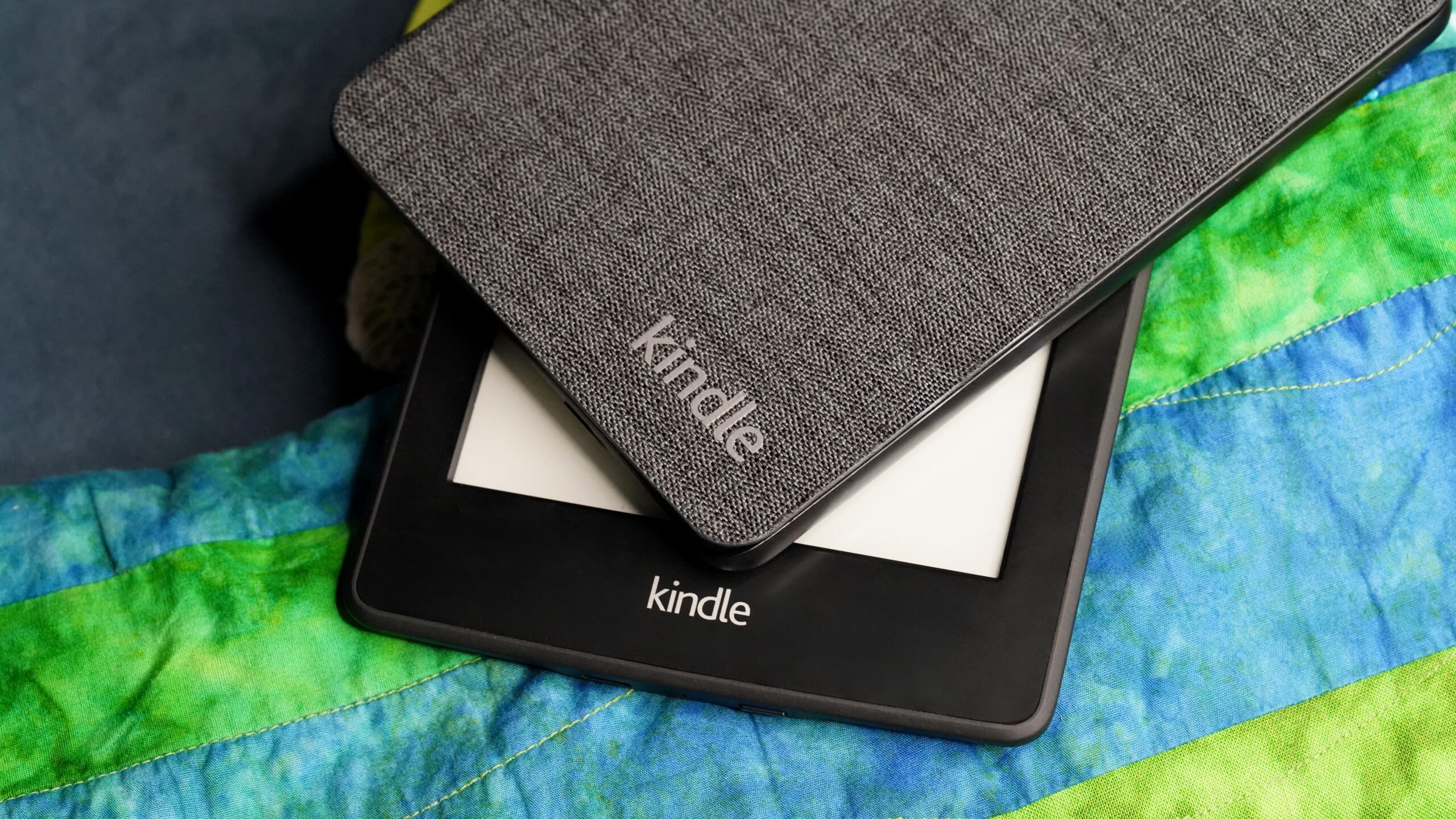 Kindle Plus logo and e-reader screen showing digital books