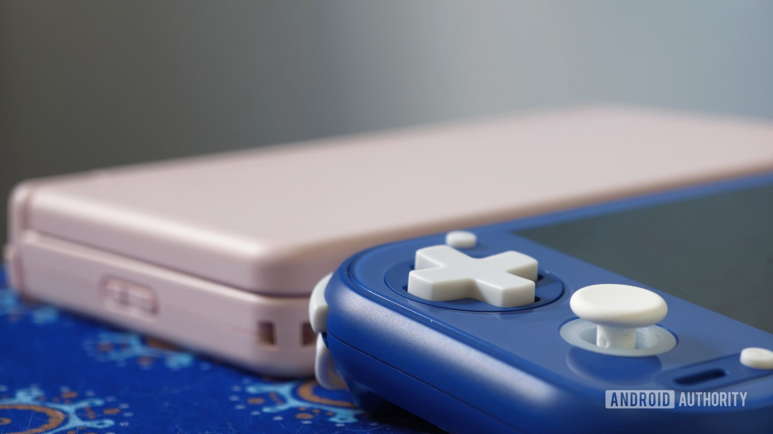 Two ANBERNIC handheld gaming consoles displayed side by side