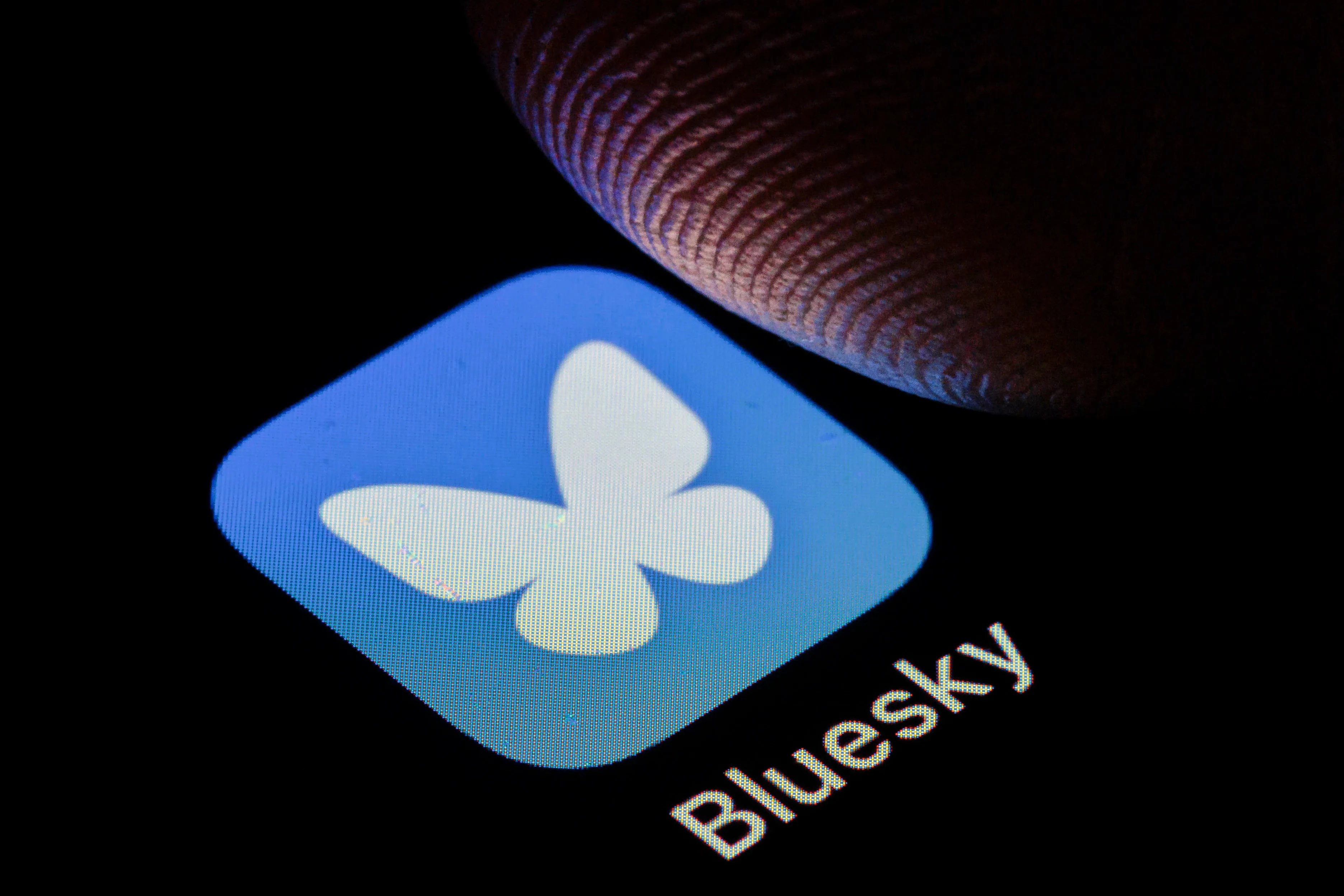 Bluesky logo on a smartphone screen.