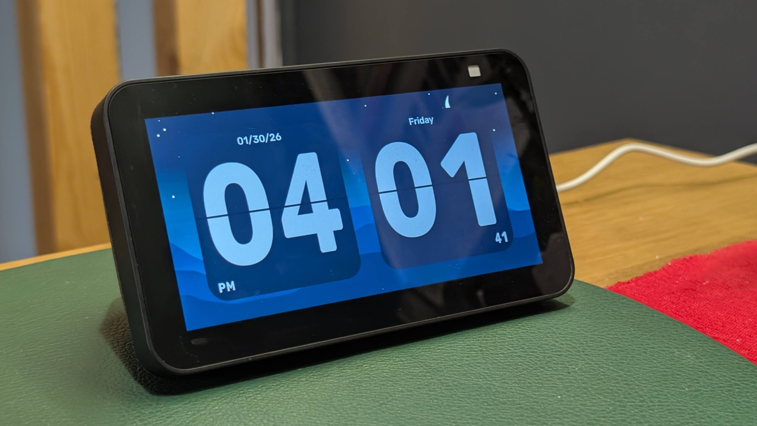 An Amazon Echo Show 5 displaying the Apple CarPlay interface on a desk.