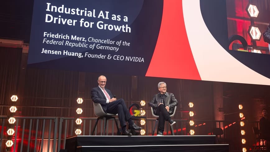 Friedrich Merz and Jensen Huang seated on stage under a screen reading “Industrial AI as a Driver for Growth”
