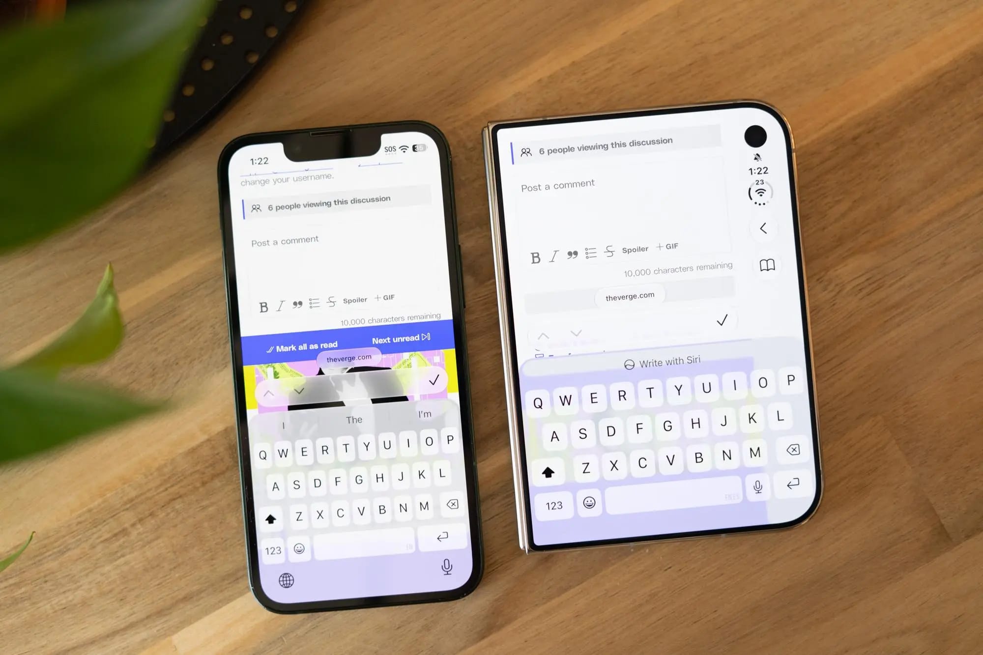 An iPhone 13 Mini next to the much wider iPhone Duo, comparing the two phones’ keyboards.
