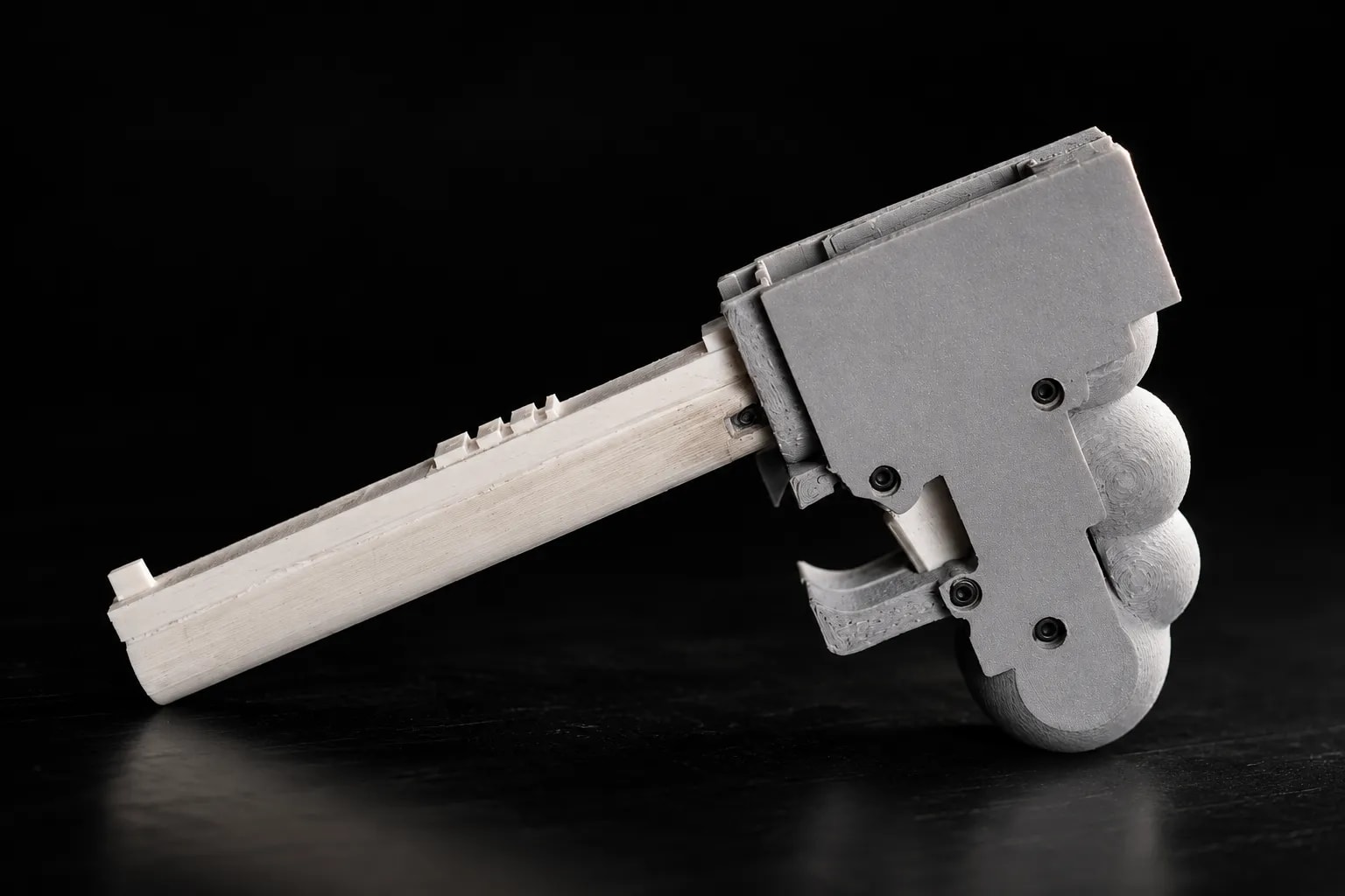A close-up of the WASP 3D-printed firearm with its unique, surreal design.