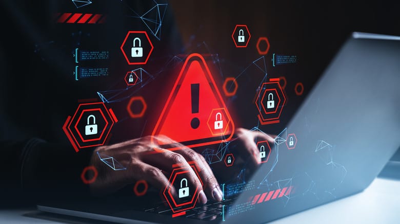 Illustration of hands at a laptop with images of caution and danger floating above the keyboard.