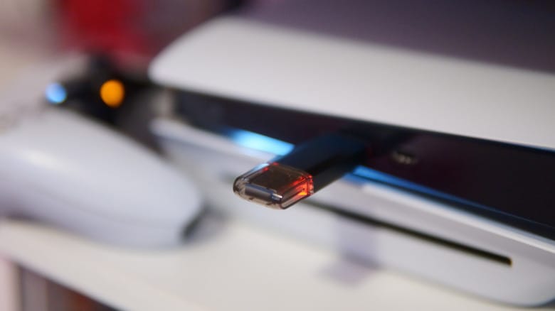A USB flash drive plugged into a PS5 console.