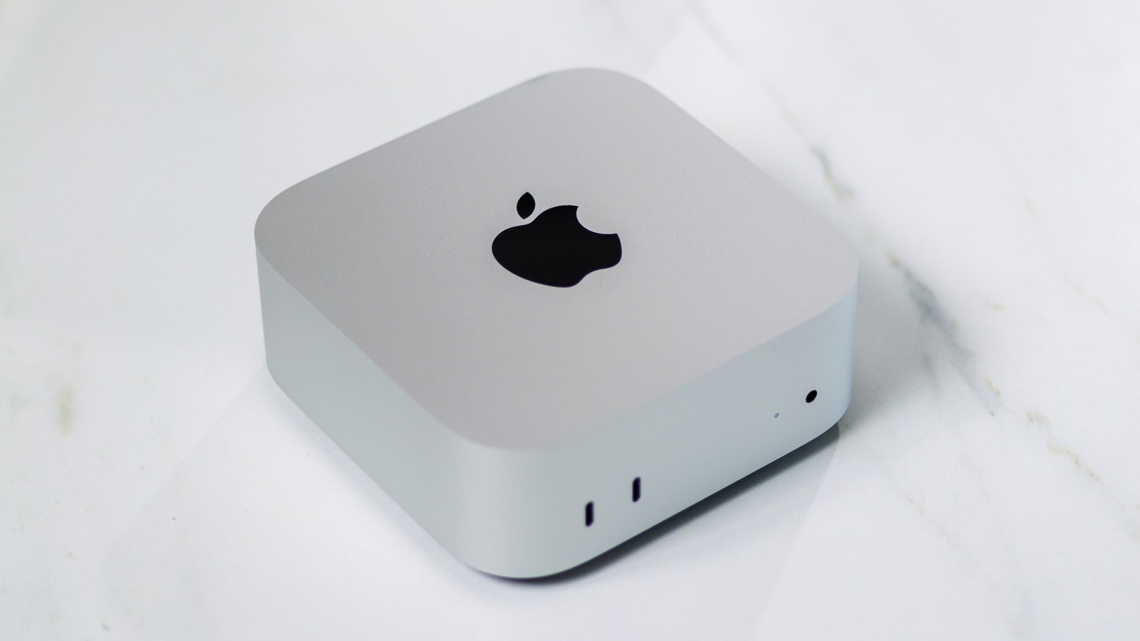 Apple Mac mini desktop computer next to a monitor