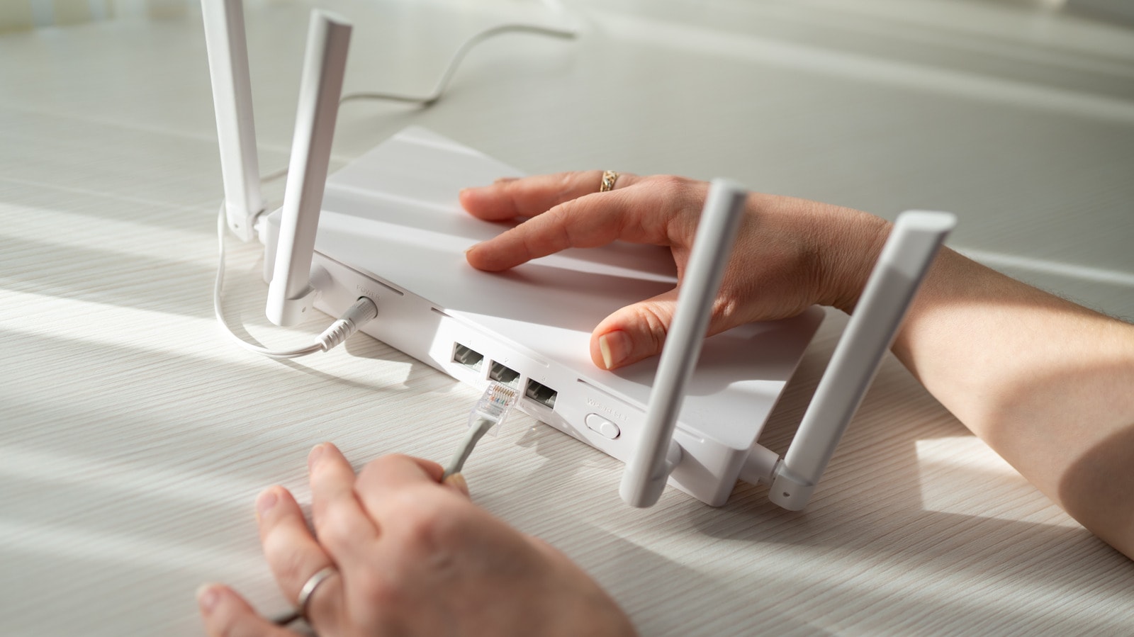 A modern Wi-Fi router placed in a central, open area of a home.
