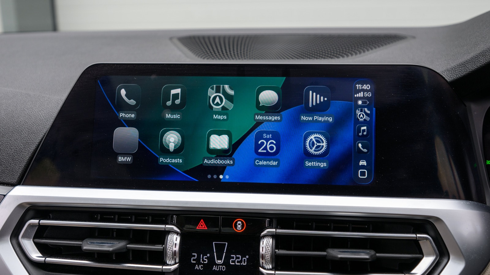 A smartphone connected to a car dashboard via a wireless CarPlay adapter