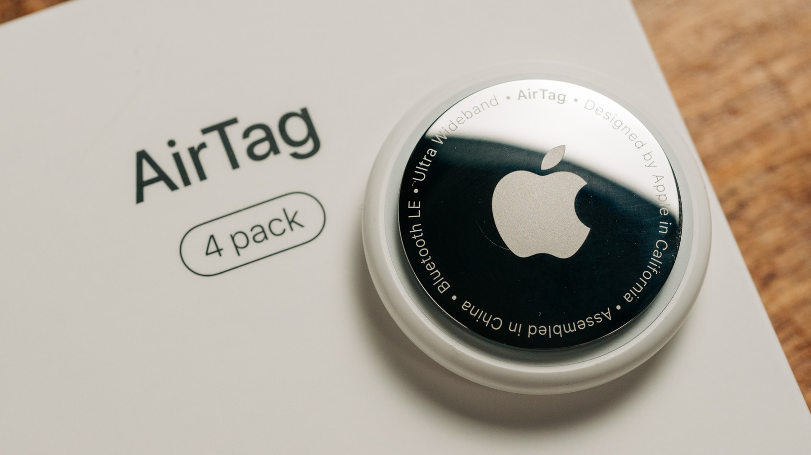 An Apple AirTag resting on a flat surface