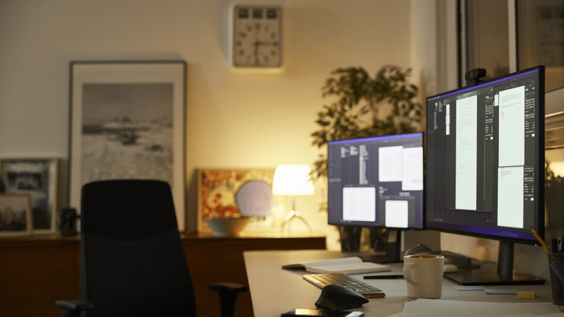 A desk setup featuring multiple monitors and a single keyboard and mouse.