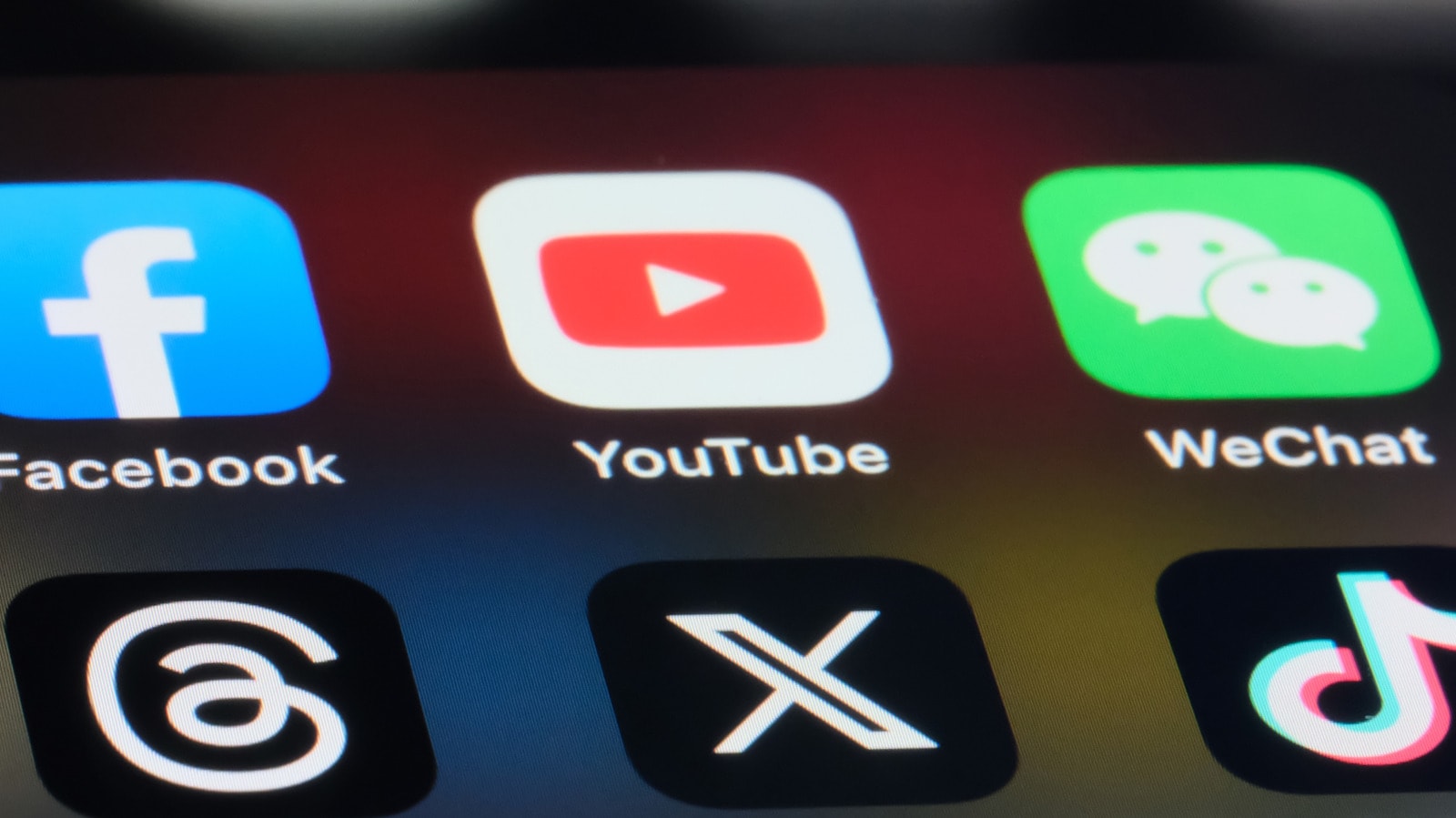 Smartphone displaying social media icons with a digital security lock symbol.