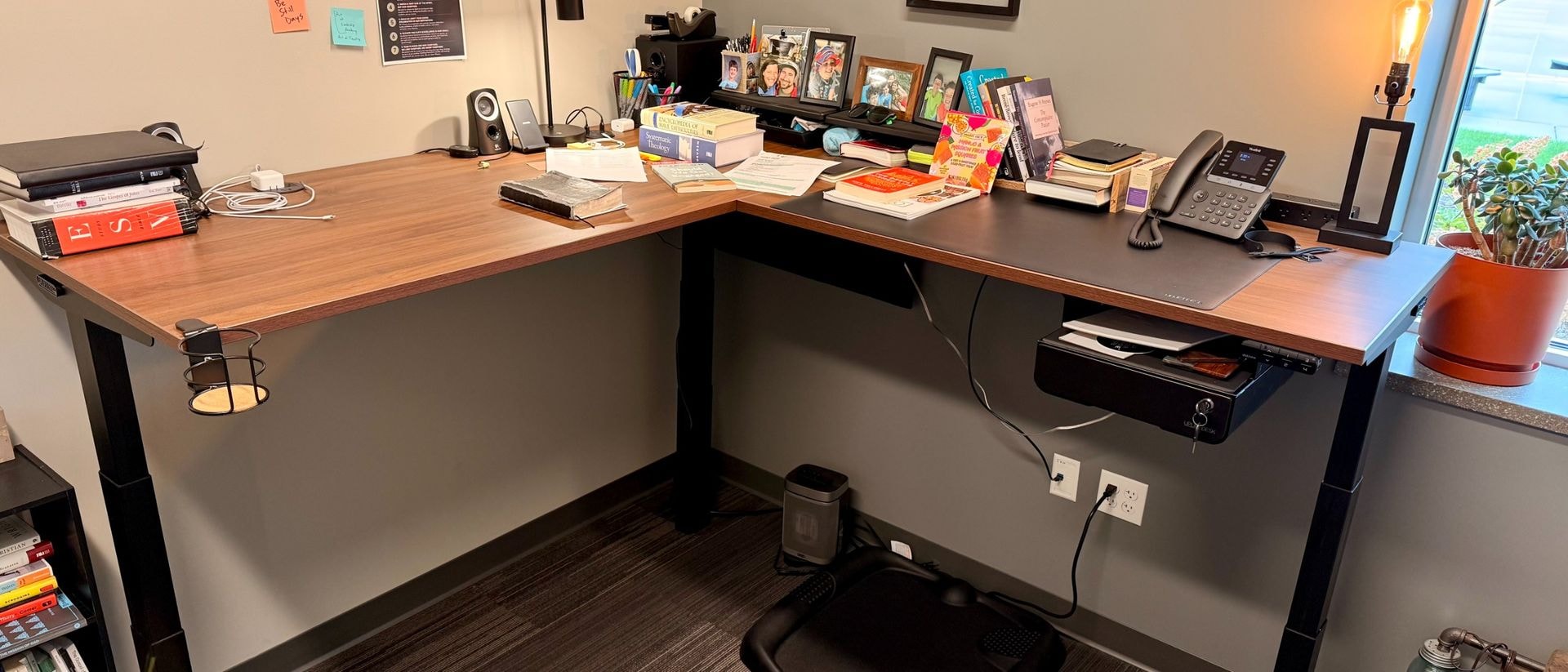 Uplift V3 L-shaped standing desk in a modern office setting