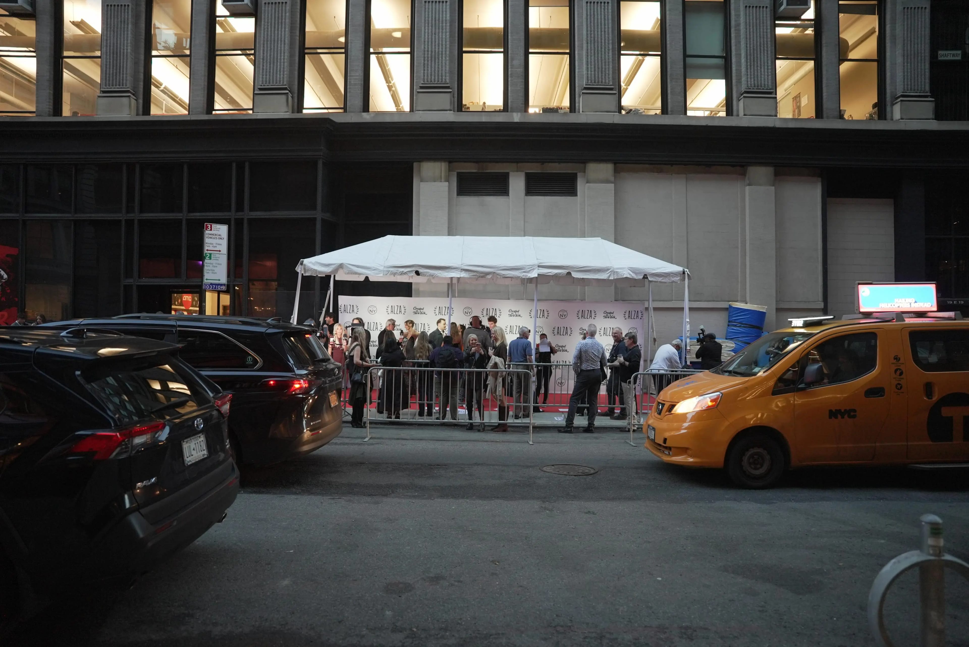 A photograph of a tented red carpet area next to a movie theater.