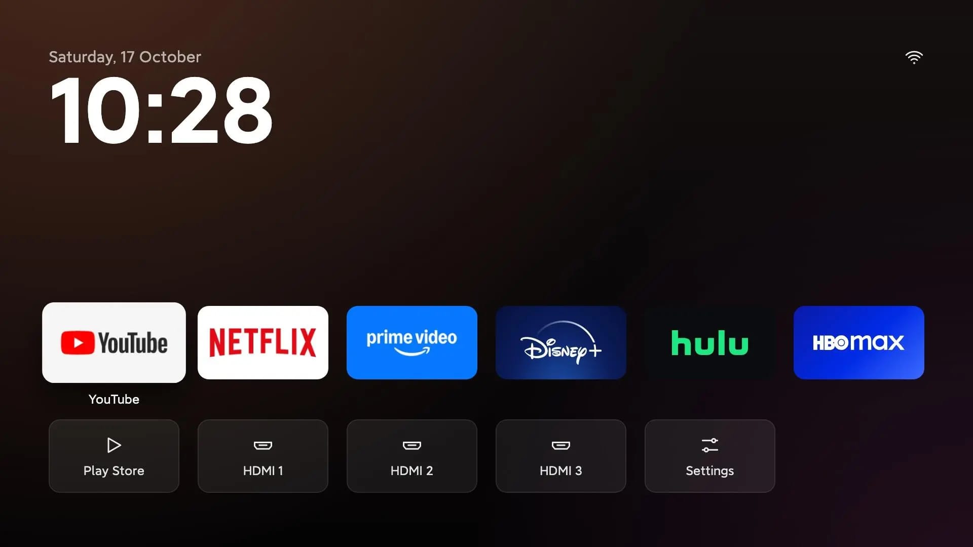 A TV operating system home page without ads and large tiles to select different streaming services and TV inputs.