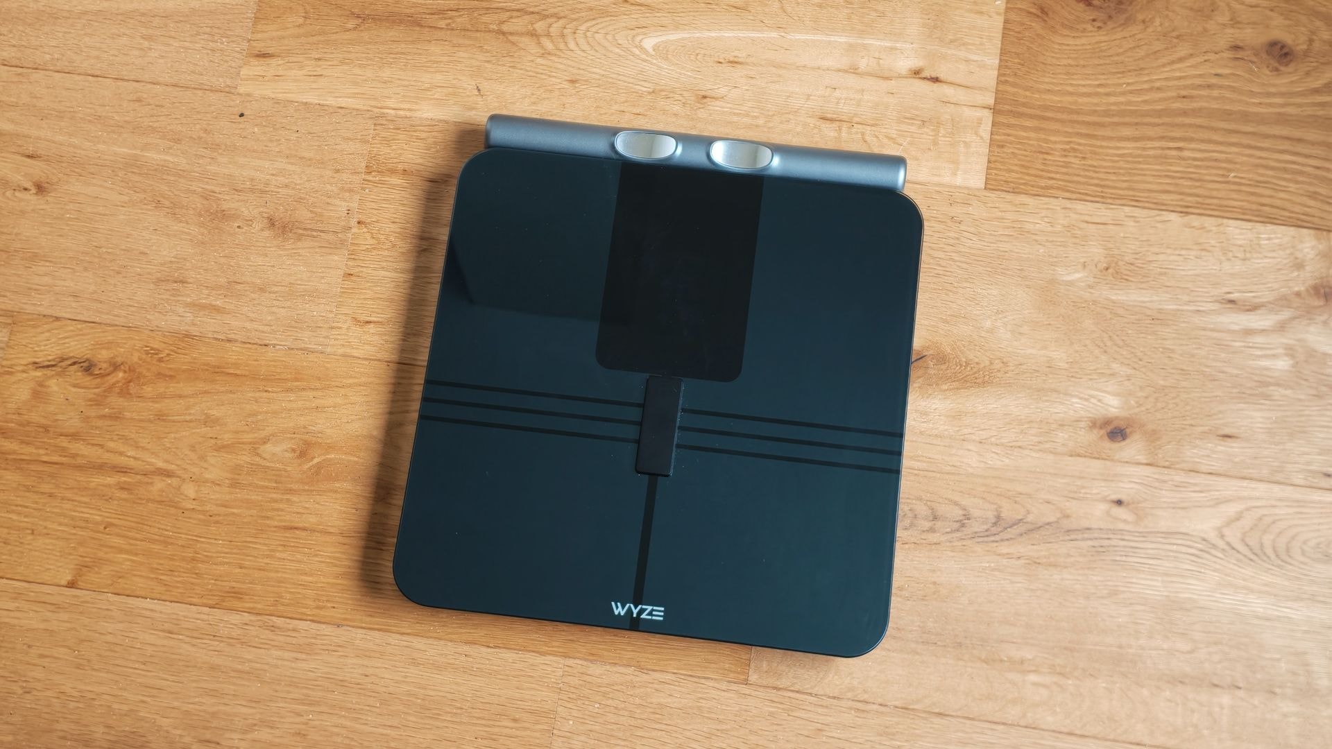 The Wyze BodyScan smart scale with its large LED display and handheld unit.