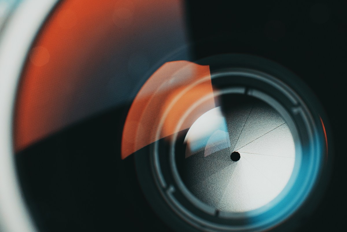 OpenAI logo and smartphone camera lens technology
